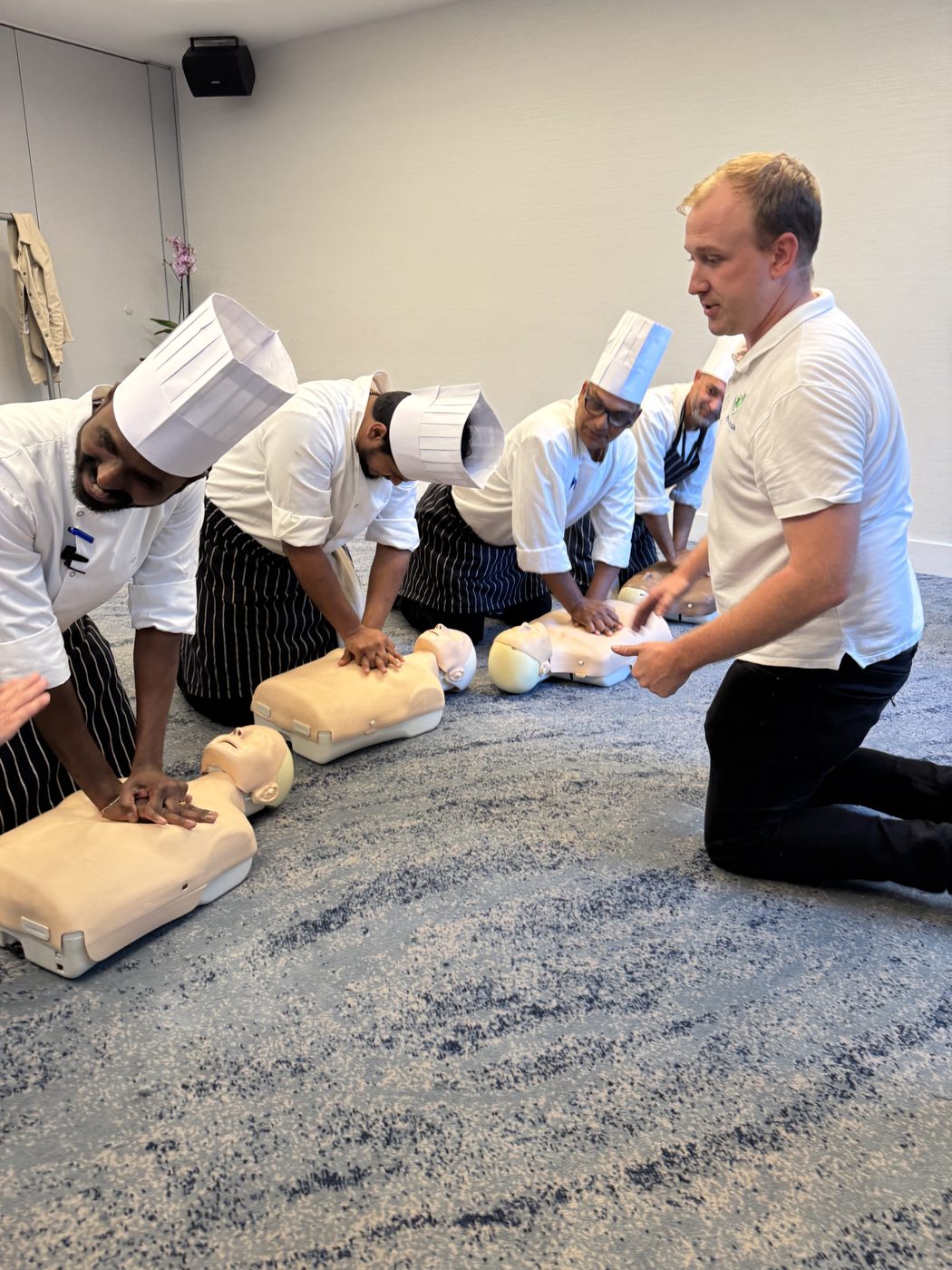 First Aid for Life trainer coaching chefs on CPR technique